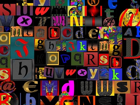 Jumble of colorful letters on black background.