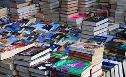 Stacks of colorful books displayed on a table.